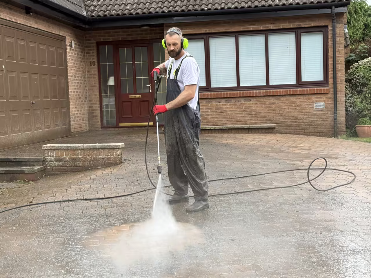 Michael at work pressure washing a driveway in Edinburgh